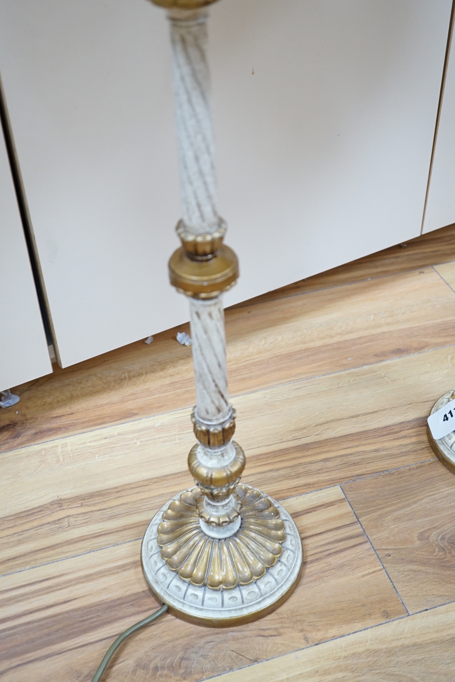 A pair of gilt and cream painted lamps, 83cm high
